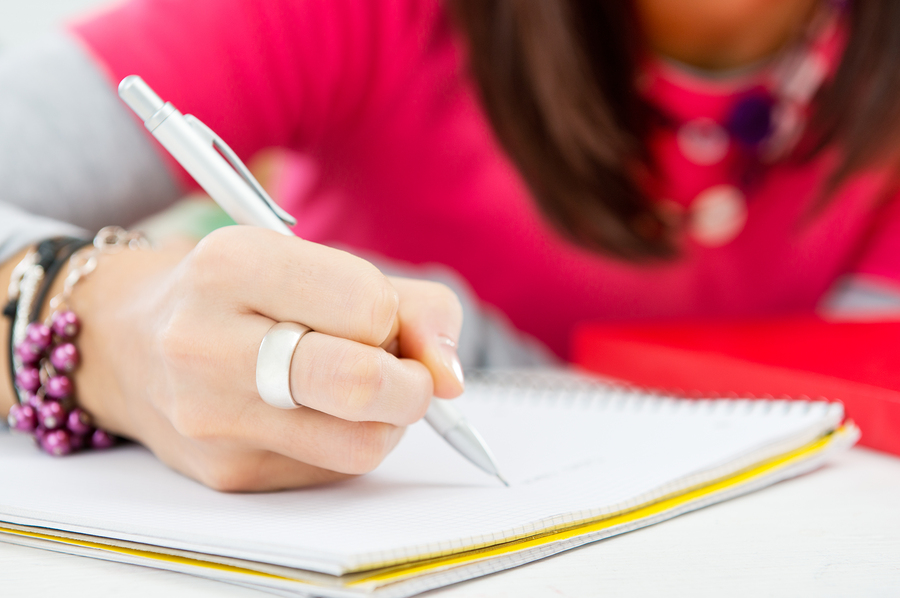 Closeup Of Student Hand Writing On Paper